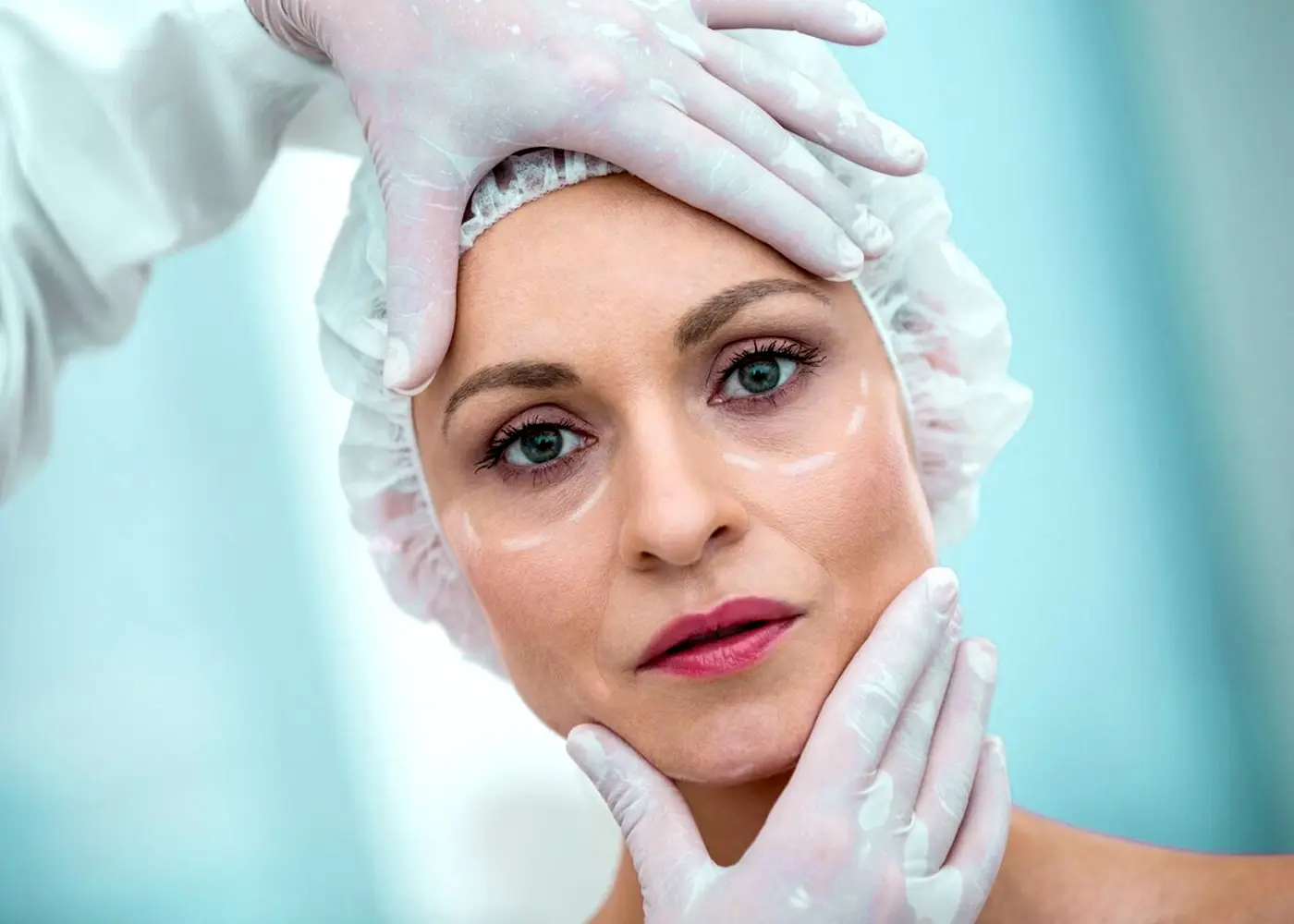 Close-up of a woman's face being marked for anti-wrinkle treatment, emphasizing precision and care.